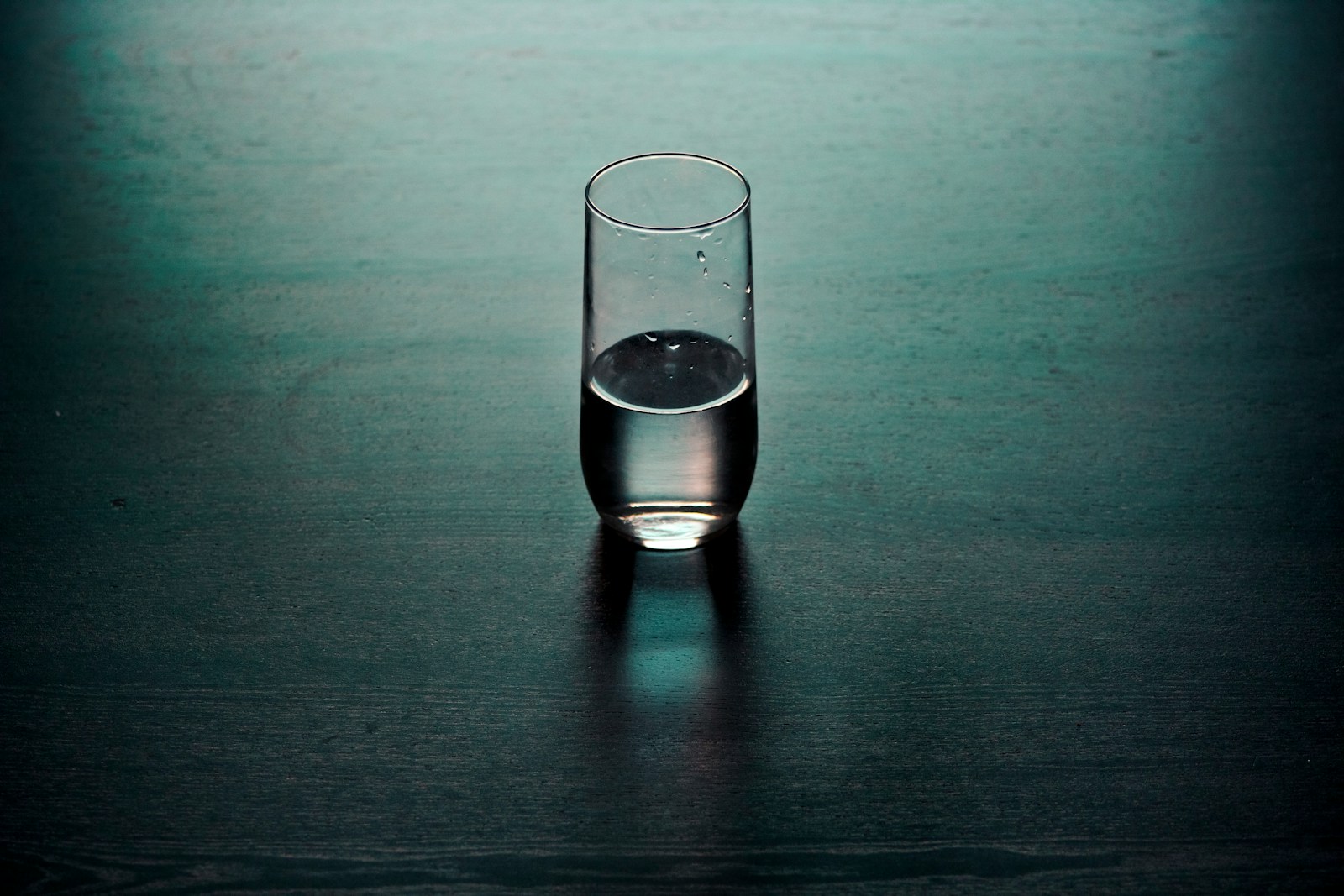 clear drinking glass on brown wooden surface